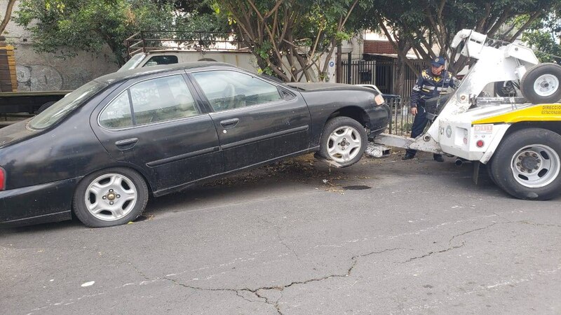 Una grúa se lleva un coche negro