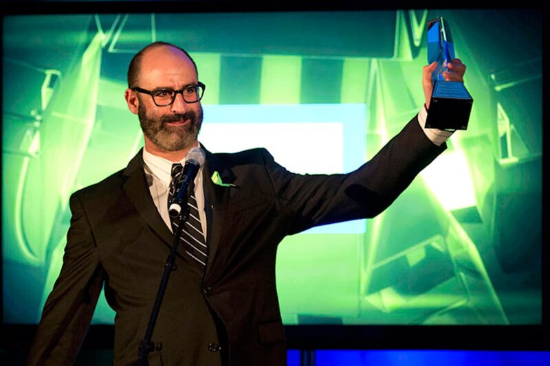 Un hombre sostiene un premio