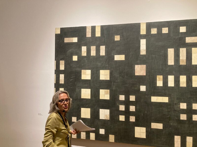 Mujer frente a una pintura abstracta