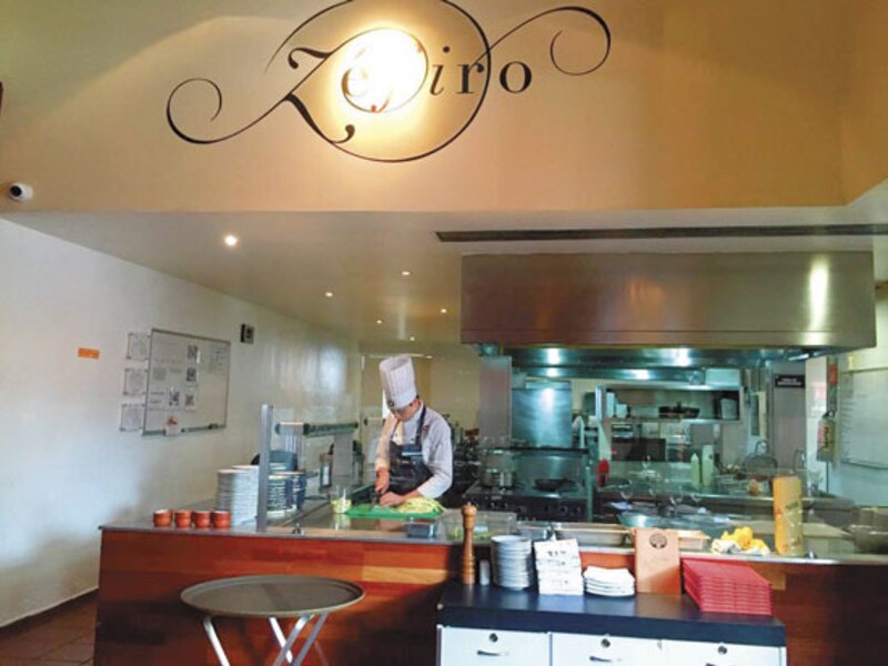 El chef preparando un plato en la cocina del restaurante.
