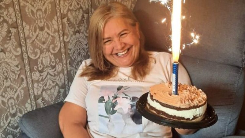 Mujer celebrando su cumpleaños con una tarta