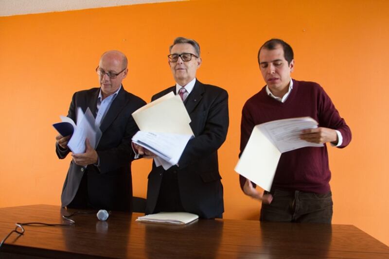 Tres hombres leyendo documentos