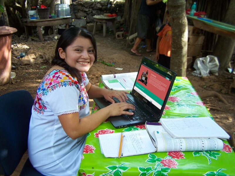 Estudiante usando una computadora portátil en una zona rural