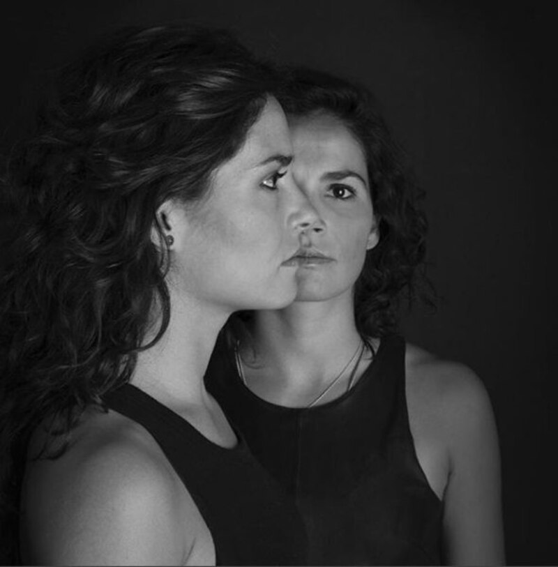 Retrato en blanco y negro de dos mujeres jóvenes mirándose fijamente.