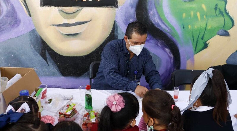 Un maestro de química en una escuela primaria realiza un experimento con sus alumnos