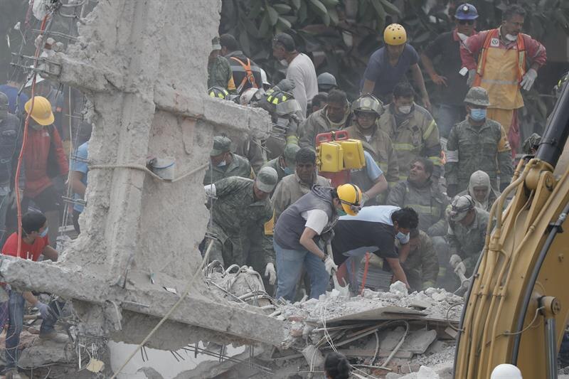 Rescatistas buscan sobrevivientes entre los escombros de un edificio colapsado