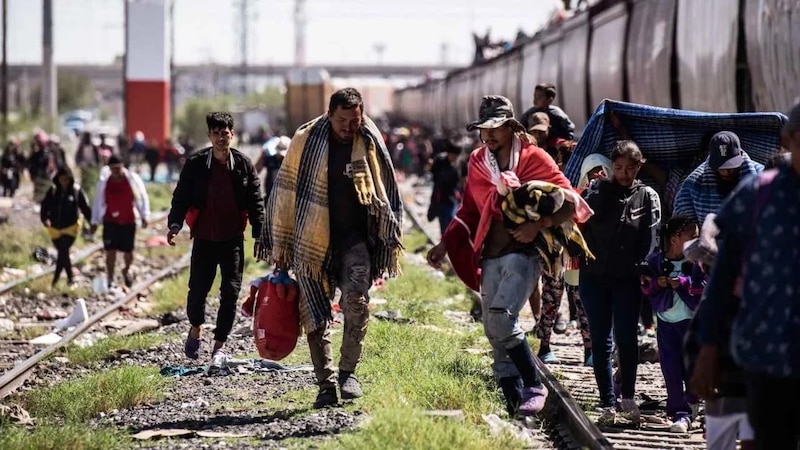 Migrantes caminan por las vías del tren en busca de una mejor vida