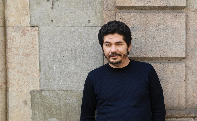 Retrato de un hombre barbudo con pelo negro y rizado