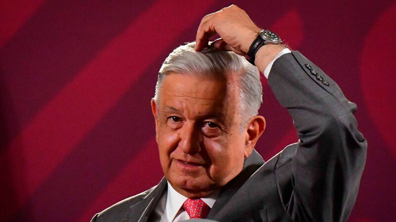 El presidente Andrés Manuel López Obrador se rasca la cabeza durante una conferencia de prensa.