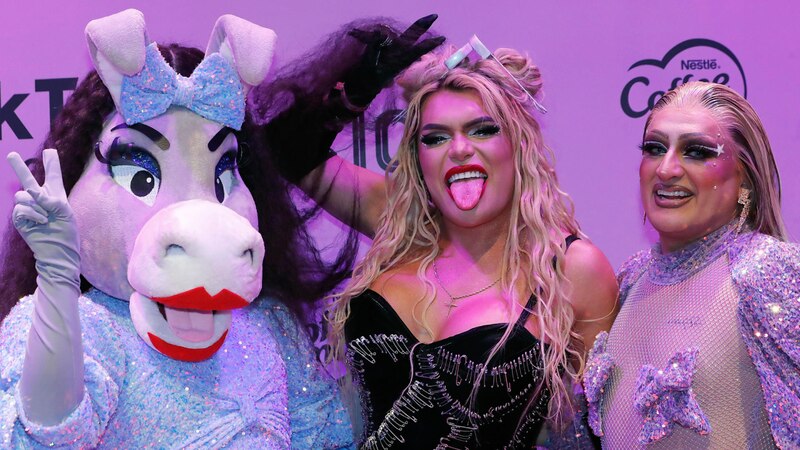 La artista brasileña Pabllo Vittar junto a la mascota de Nescafé, Pelusa, en la alfombra rosa de los Premios Tu Música Urbano 2022.