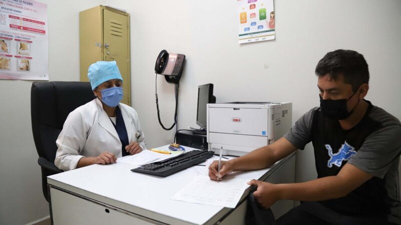 Paciente firma documentos en una clínica
